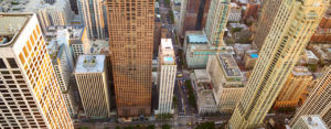 An overhead daytime view of downtown angular buildings